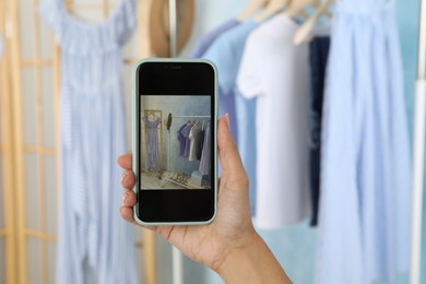 Blogger taking photo of stylish clothes indoors, closeup. Space for text