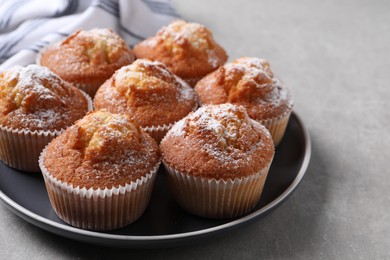 Delicious sweet muffins on light grey textured table, closeup. Space for text