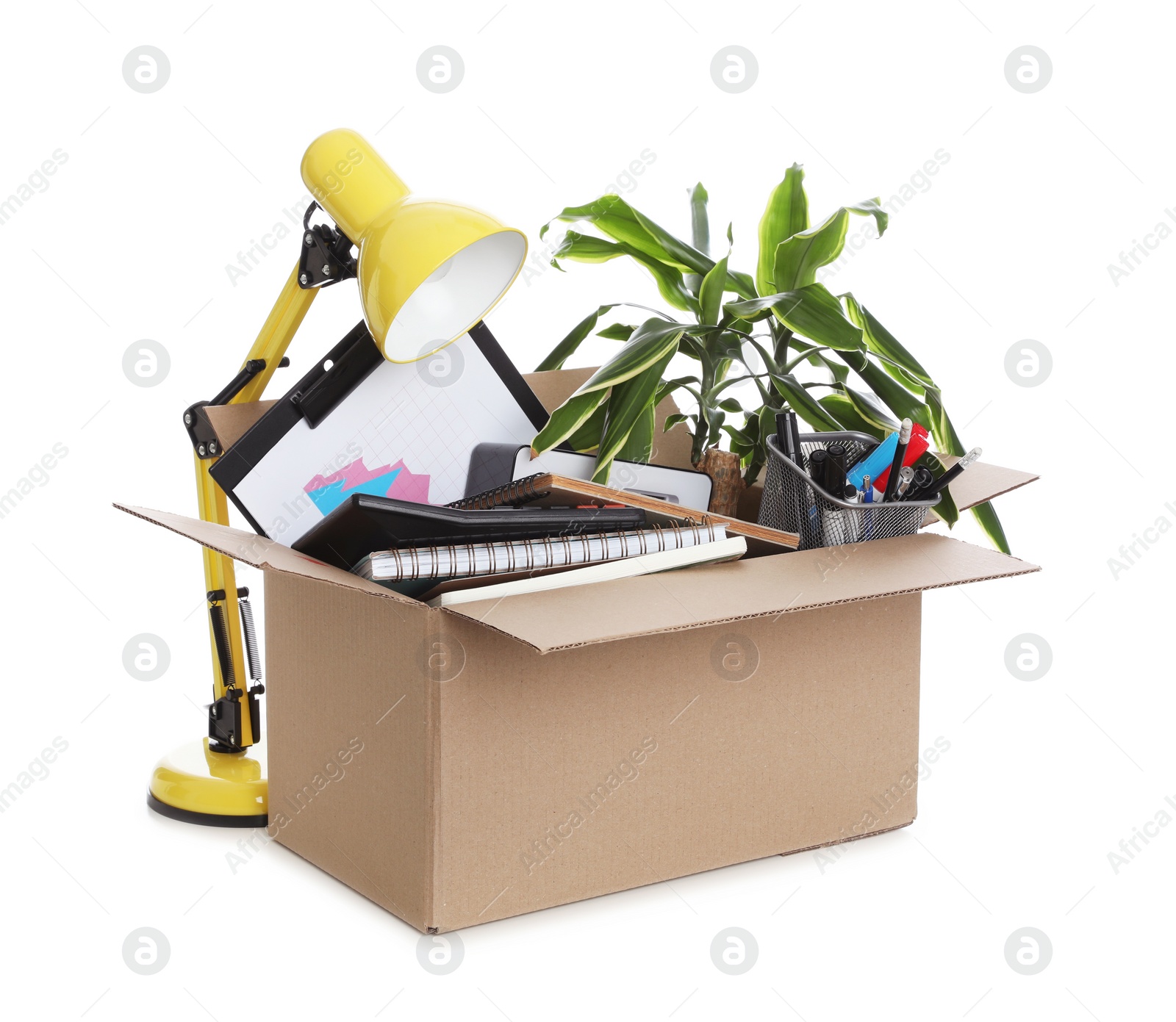 Cardboard box full of office stuff on white background Photo of Cardboard box full of office stuff on white background