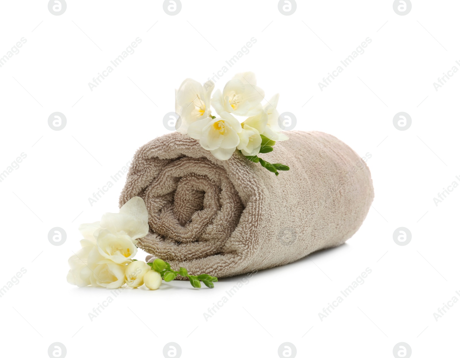 Photo of Clean rolled towel with flowers on white background