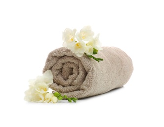 Photo of Clean rolled towel with flowers on white background