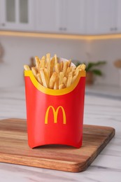 Photo of MYKOLAIV, UKRAINE - AUGUST 12, 2021: Big portion of McDonald's French fries on marble table in kitchen