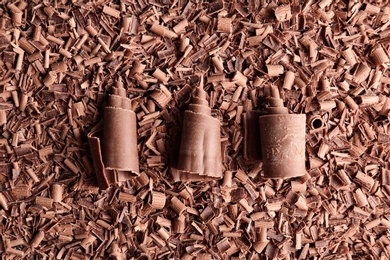 Photo of Pile of tasty chocolate curls as background, top view