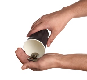 Photo of Poor man holding cup with coins on white background, closeup