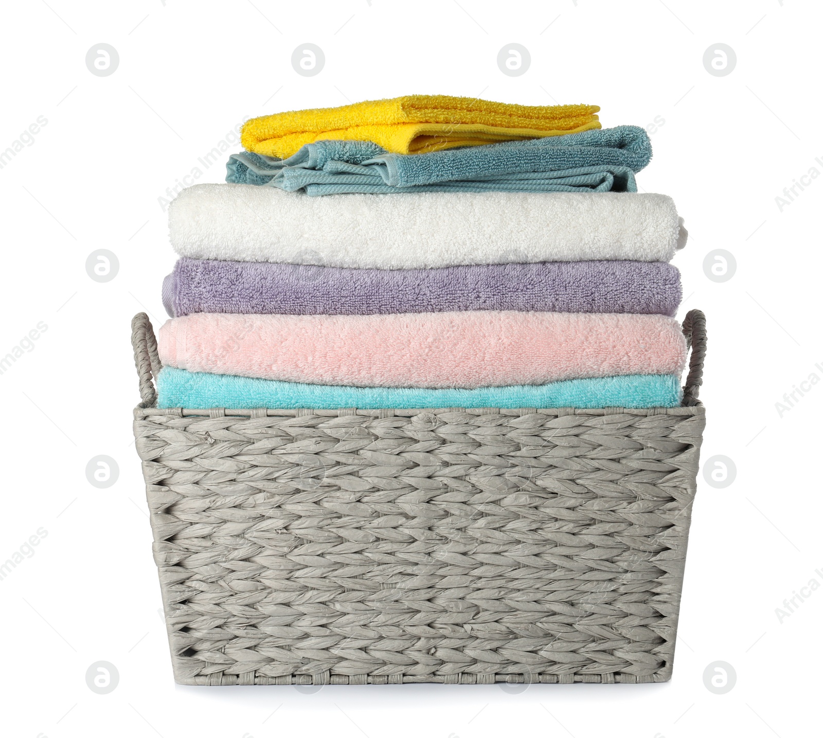 Photo of Wicker laundry basket with clean towels on white background