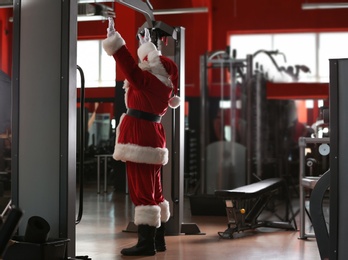 Photo of Authentic Santa Claus training in modern gym