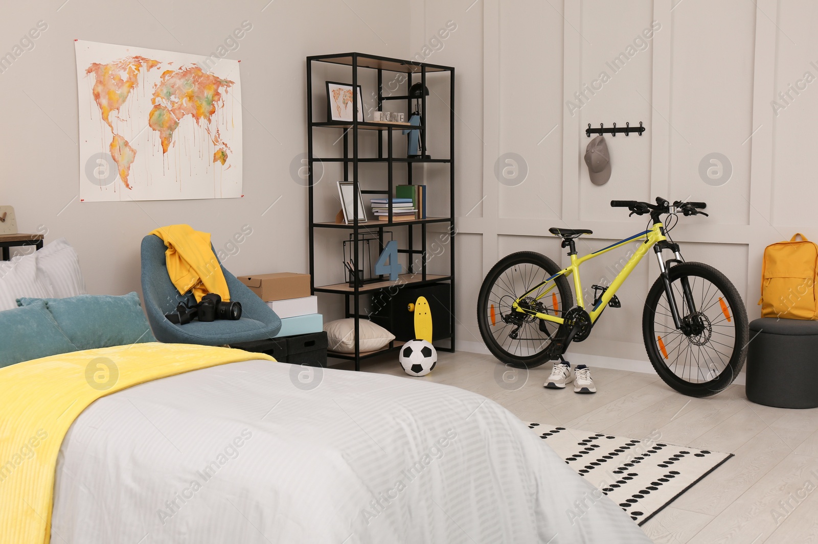 Photo of Stylish teenager's room interior with comfortable bed and sports equipment