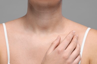 Photo of Closeup view of woman with normal skin on grey background