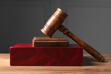Photo of Law. Book and gavel on wooden table