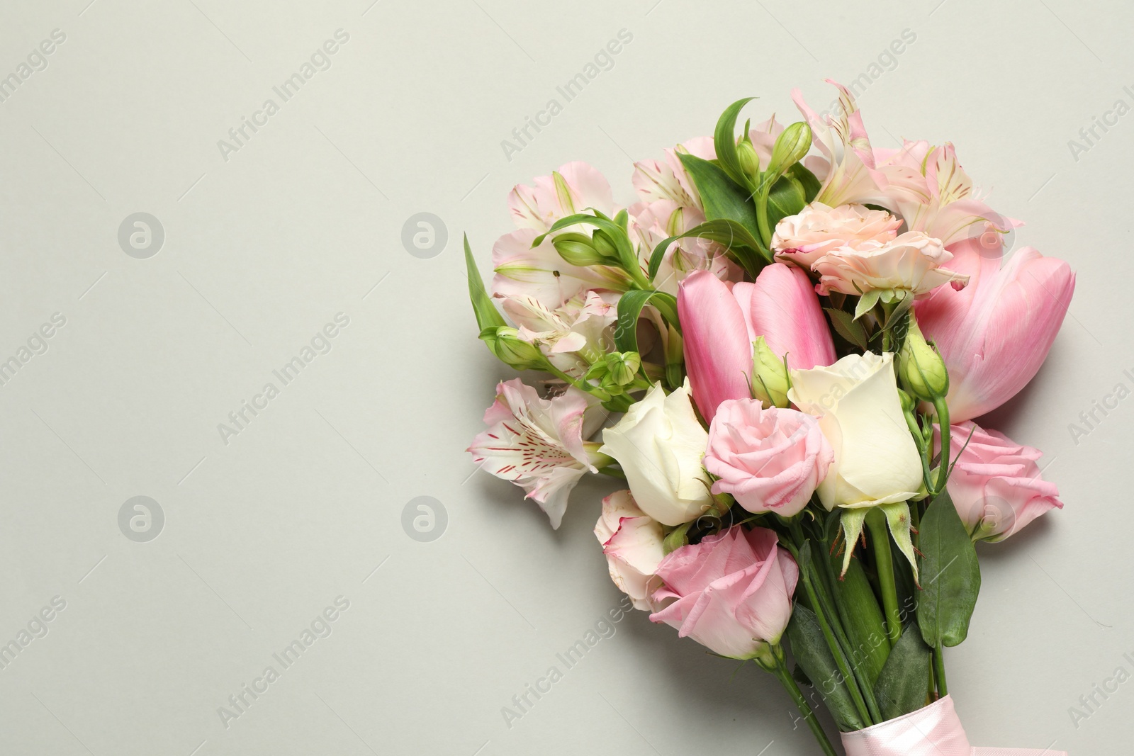 Happy Mother's Day. Bouquet of beautiful flowers on light grey background, top view. Space for text Photo of Happy Mother's Day. Bouquet of beautiful flowers on light grey background, top view. Space for text