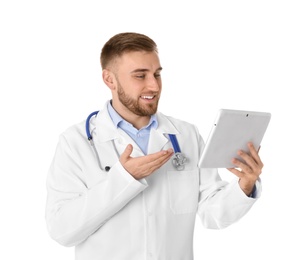 Photo of Male doctor using video chat on tablet against white background