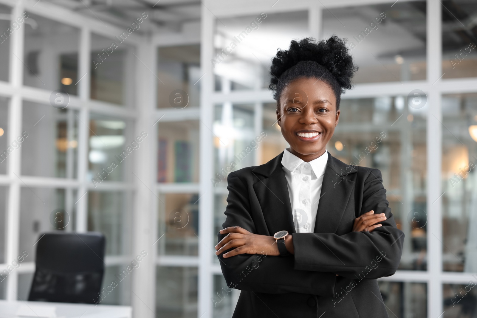 Photo of Happy woman with crossed arms in office, space for text. Lawyer, businesswoman, accountant or manager