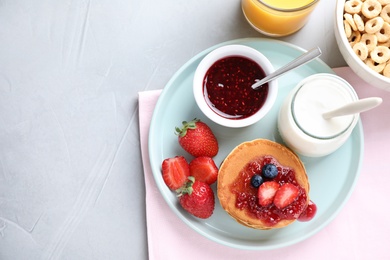 Photo of Flat lay composition with tasty pancakes on light grey table, space for text . Healthy breakfast