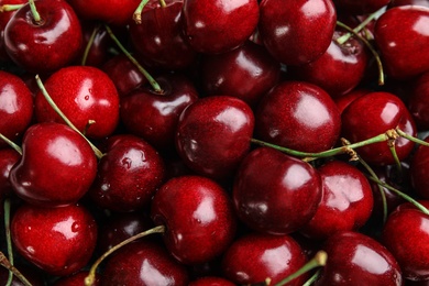 Photo of Delicious ripe sweet cherries as background, top view