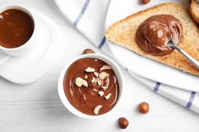 Photo of Sweet chocolate mousse served with coffee on wooden table, flat lay