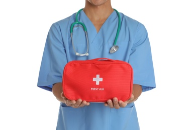 Photo of Male doctor holding first aid kit on white background, closeup. Medical object