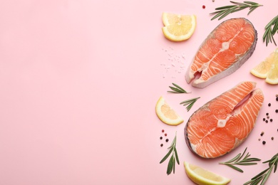 Photo of Flat lay composition with salmon steaks on pink background. Space for text
