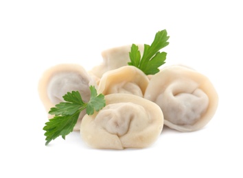 Photo of Pile of boiled dumplings with parsley leaves on white background