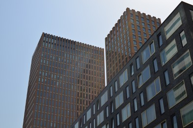 Photo of Exterior of beautiful modern skyscrapers against blue sky, low angle view