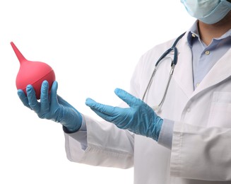 Photo of Doctor holding pink enema on white background, closeup