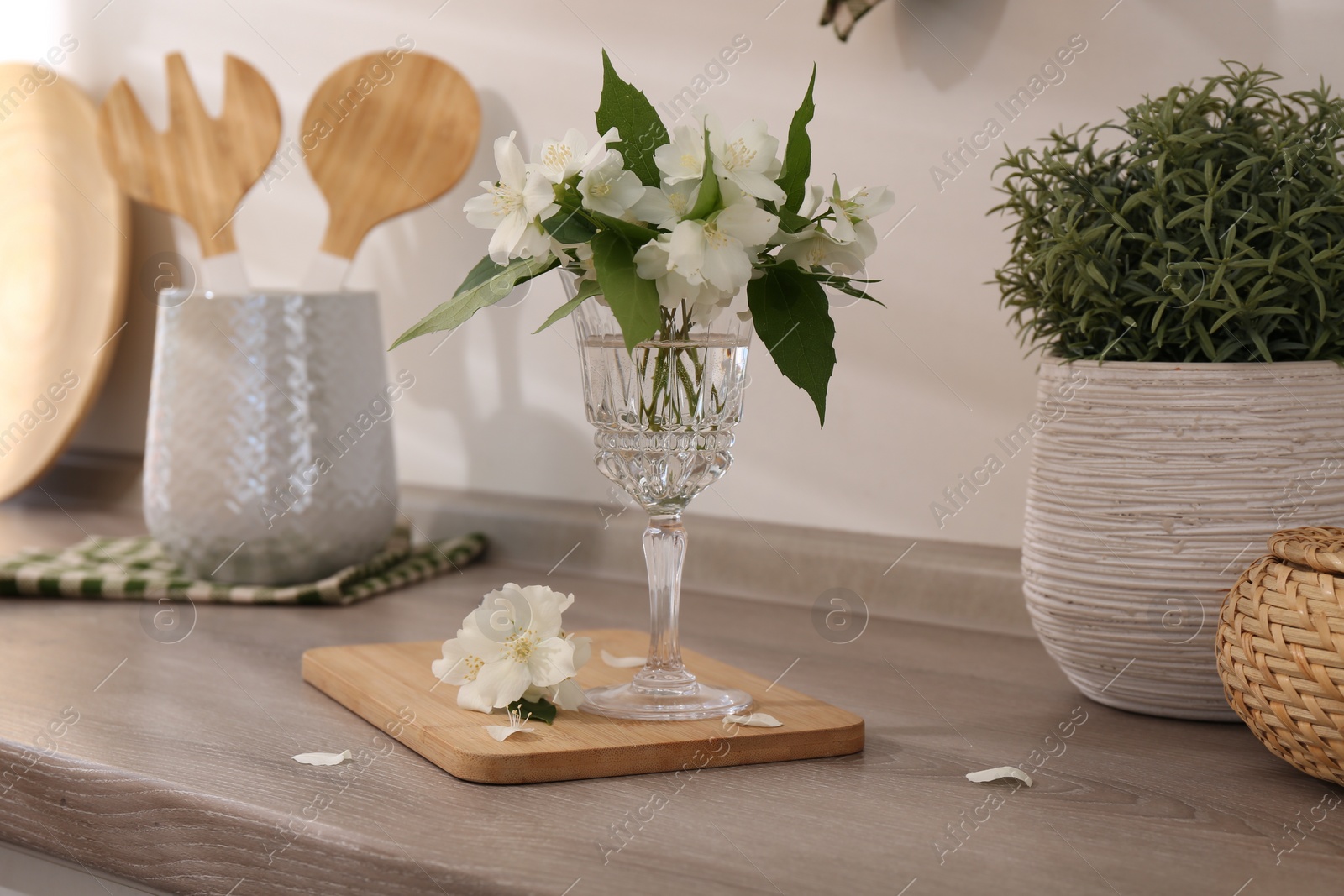 Photo of Beautiful jasmine flowers on wooden table indoors