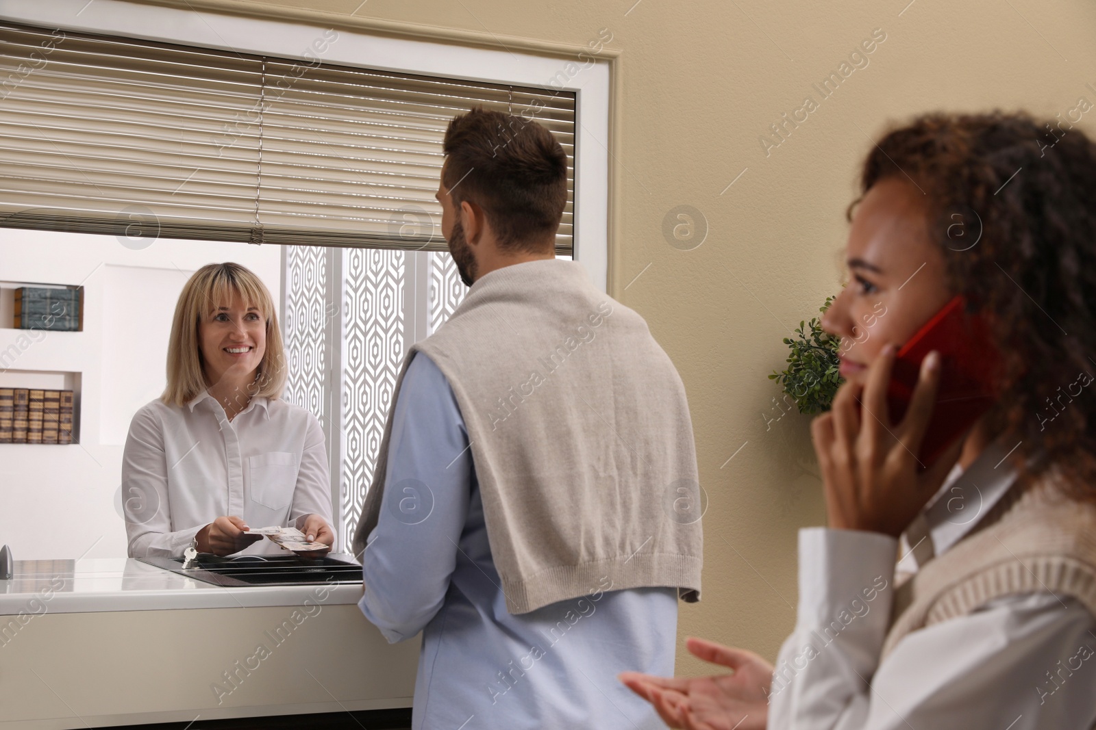 Photo of Man receiving money at cash department window in bank. Currency exchange