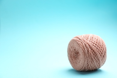 Clew of knitting threads on color background, space for text. Sewing stuff