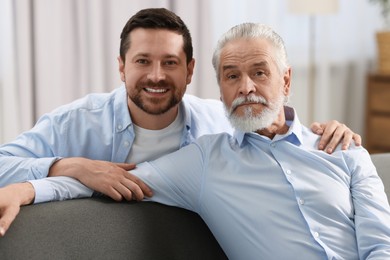 Photo of Happy son and his dad at home