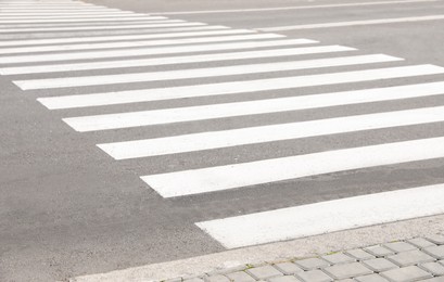 White pedestrian crossing on empty city street