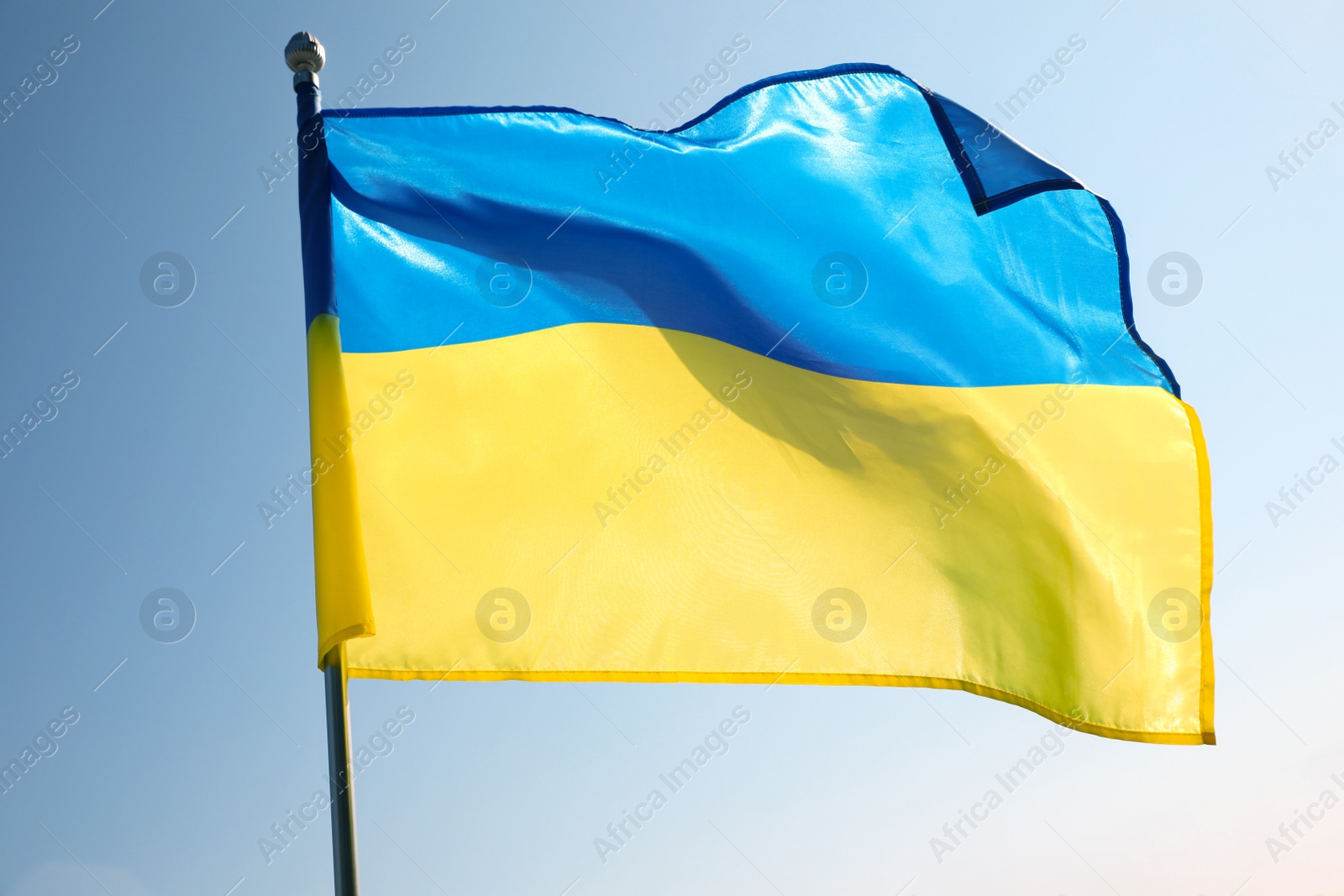 Photo of National flag of Ukraine fluttering on sunny day outdoors