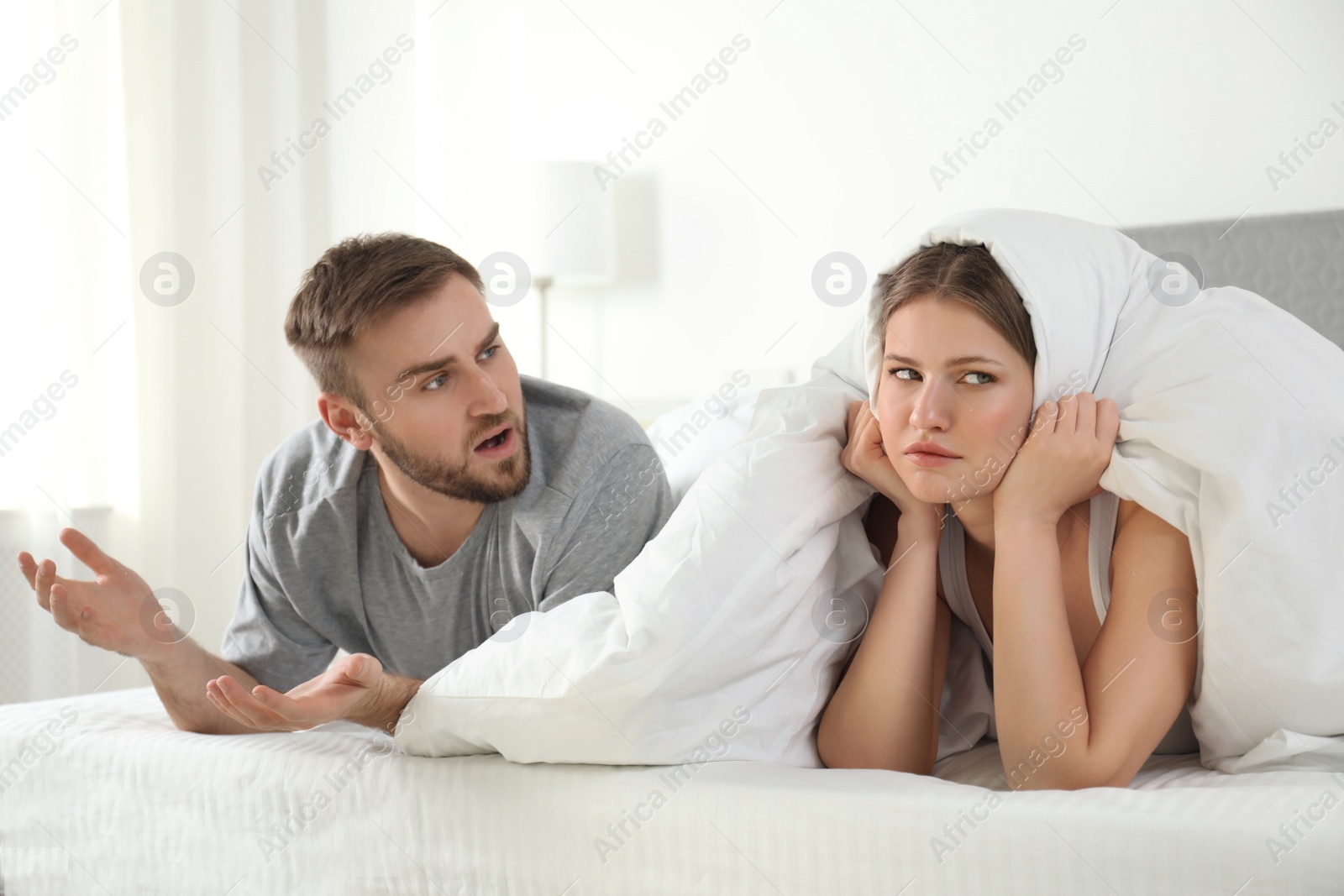 Photo of Unhappy young couple quarreling at home. Relationship problems