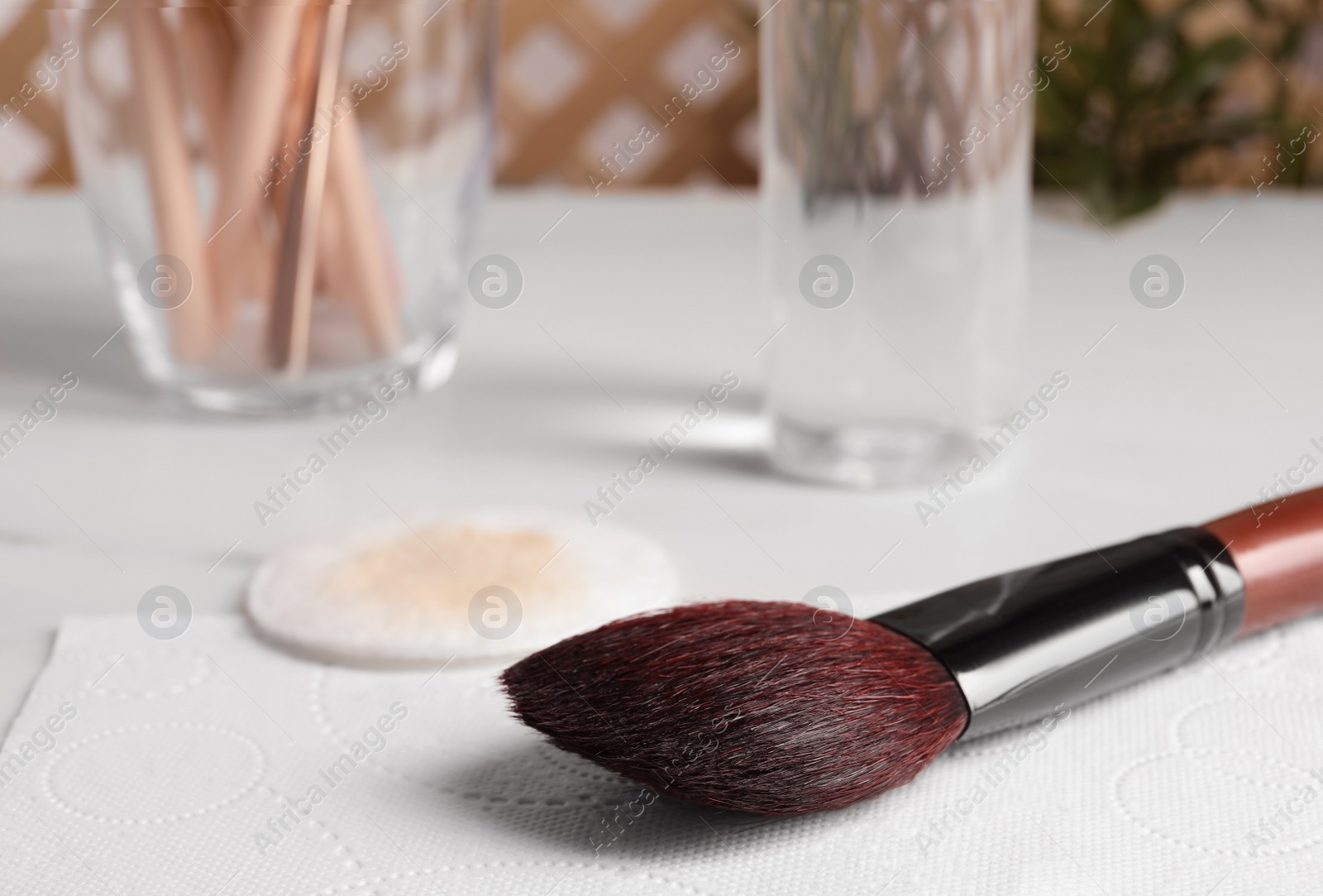 Photo of Makeup brush drying after cleaning on paper towel, closeup. Space for text