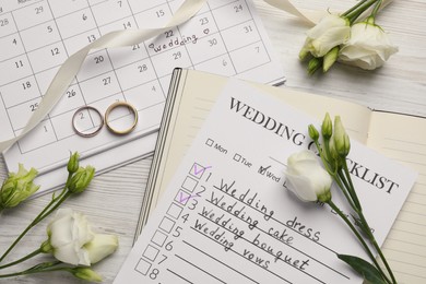 Photo of Flat lay composition with Wedding Checklist and Planner on white wooden table