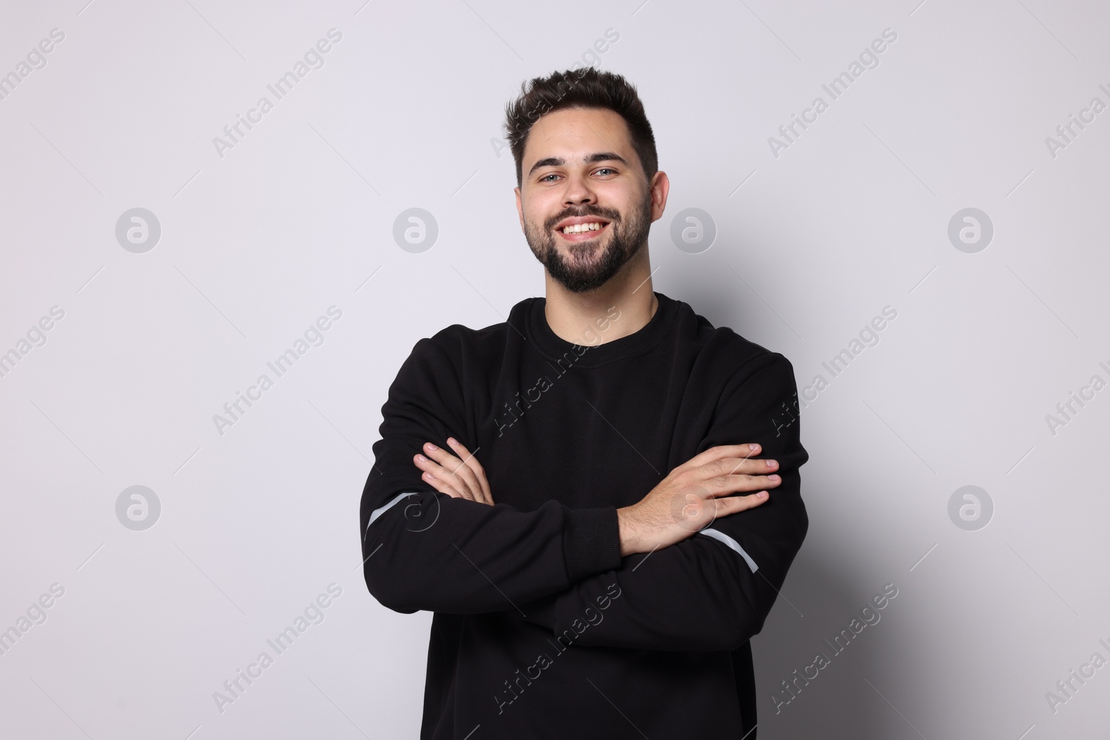 Photo of Happy man in stylish sweater on white background