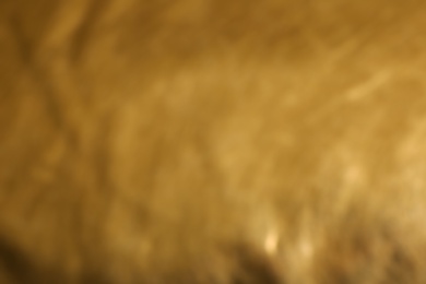 Blurred view of golden surface as background