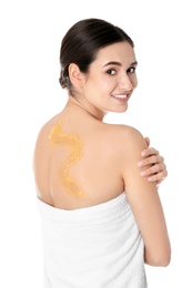 Young woman with body scrub on her back against white background
