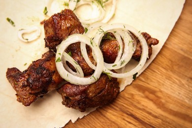 Photo of Delicious shish kebab served on wooden table, top view