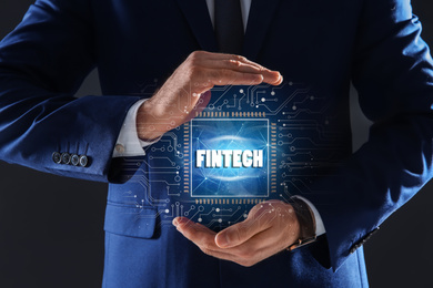 Image of Fintech concept. Man demonstrating chip and schemes, closeup