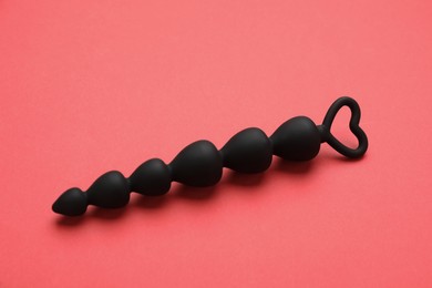 Photo of Anal beads on red background. Sex toy