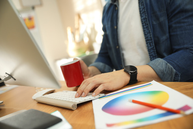 Professional designer working with computer in office, closeup