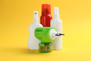 Photo of Set of different insect repellents on yellow background