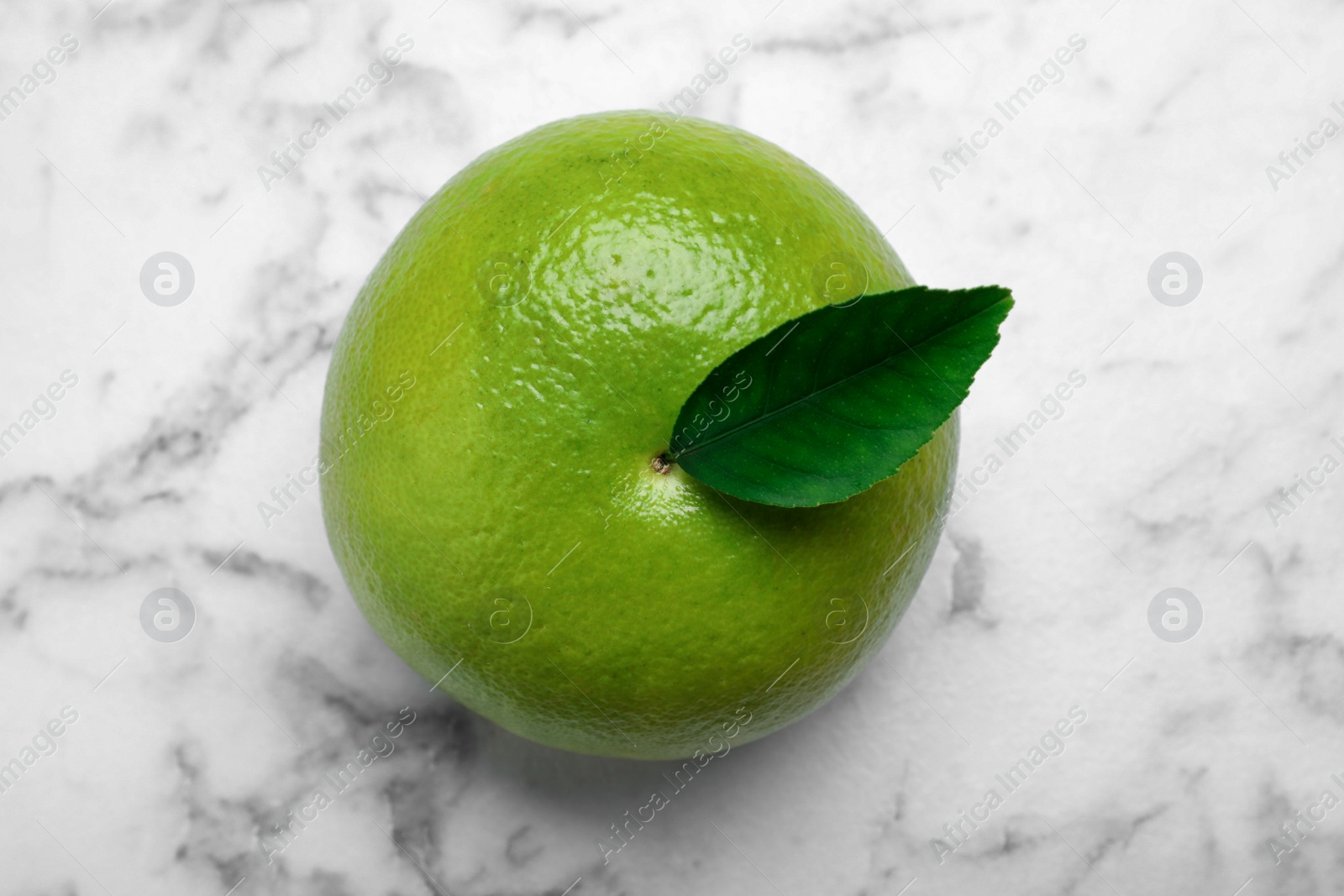 Photo of Fresh ripe sweetie fruit on white marble table, top view