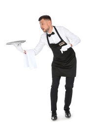 Photo of Clumsy waiter dropping empty tray on white background