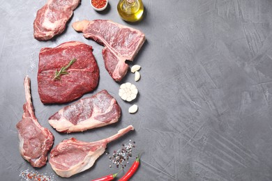 Fresh raw beef cut and spices on light grey textured table, flat lay. Space for text