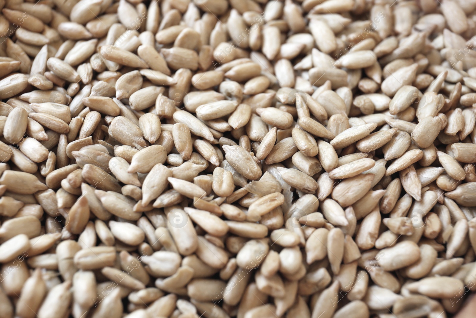 Photo of Organic sunflower seeds on table, closeup view