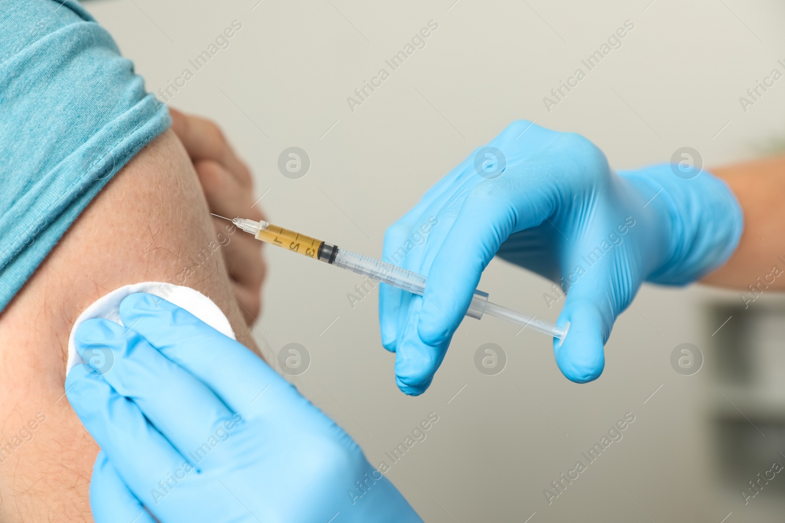 Photo of Doctor giving injection to patient in hospital, closeup. Vaccination day