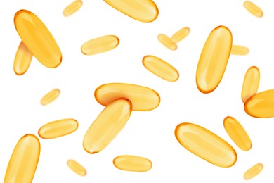 Vitamin. Softgel capsules falling on white background