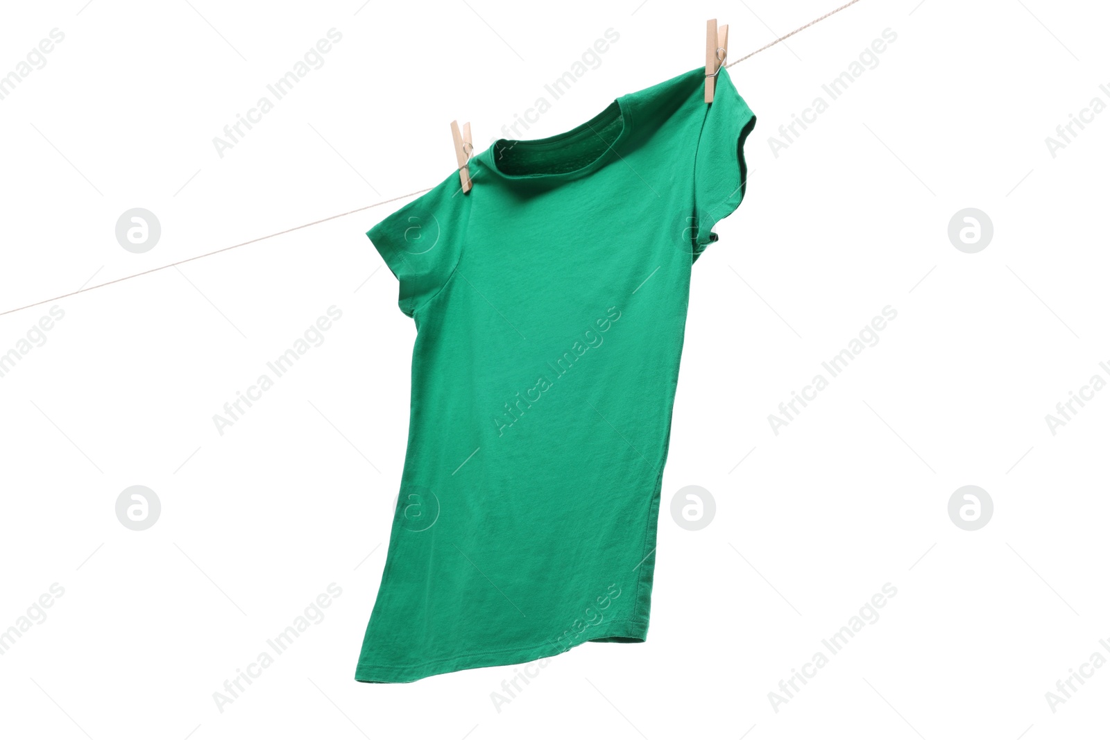 Photo of One green t-shirt drying on washing line isolated on white