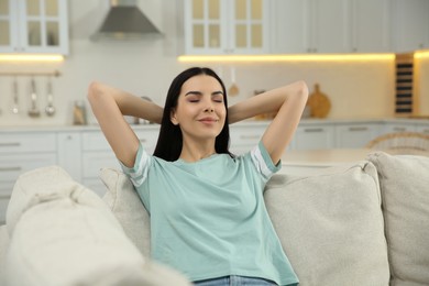 Young woman relaxing on sofa at home