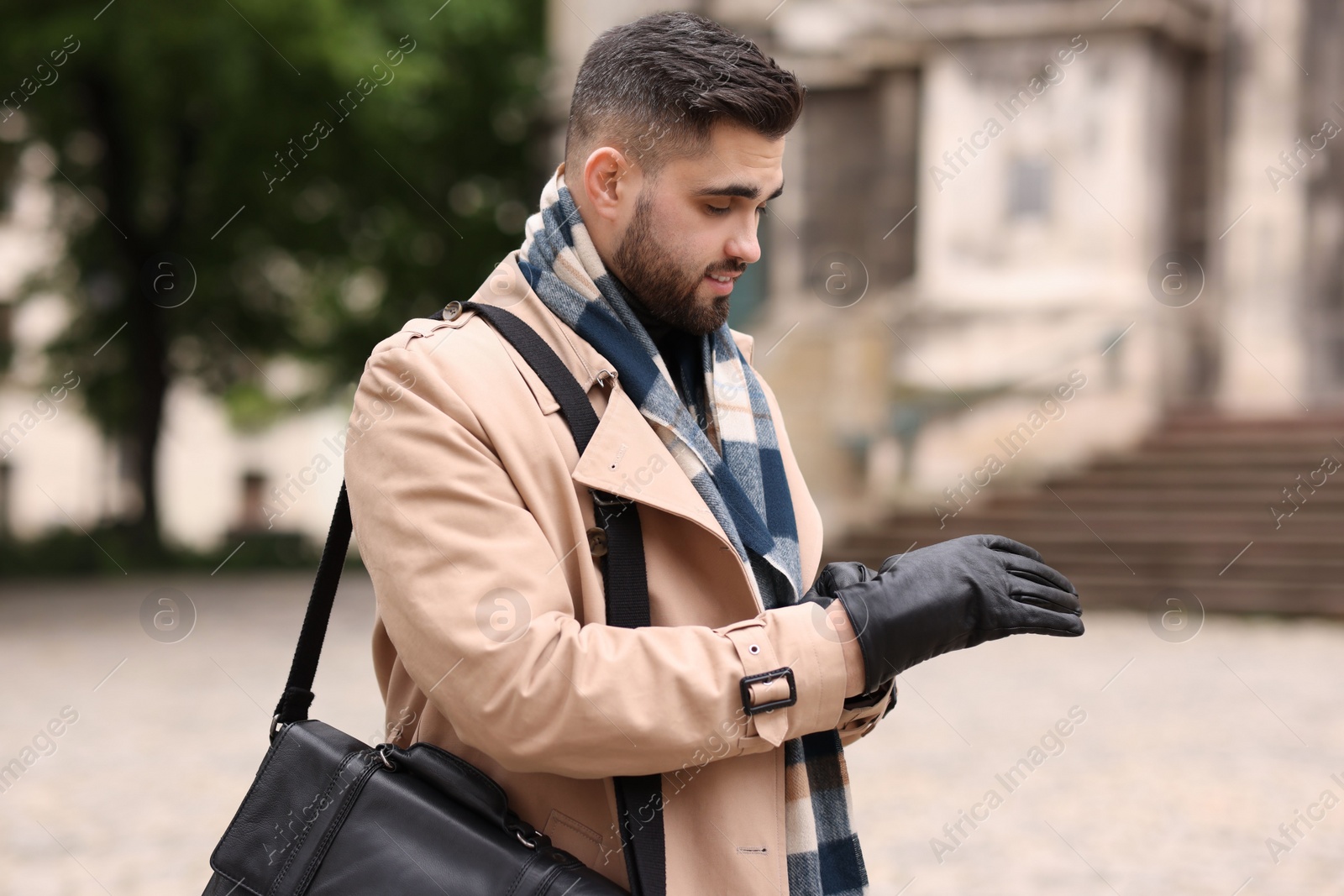 Photo of Handsome man in warm scarf on city street